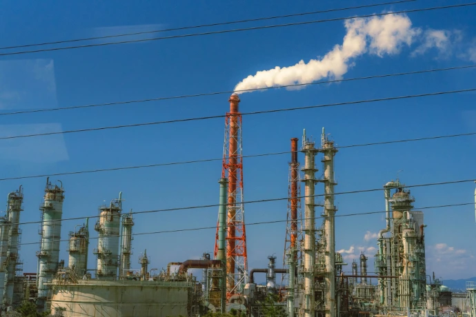 Industrial factory with smoke billowing from chimney.